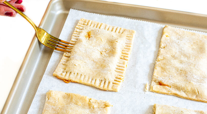 Fork crimping edges of pop tarts.