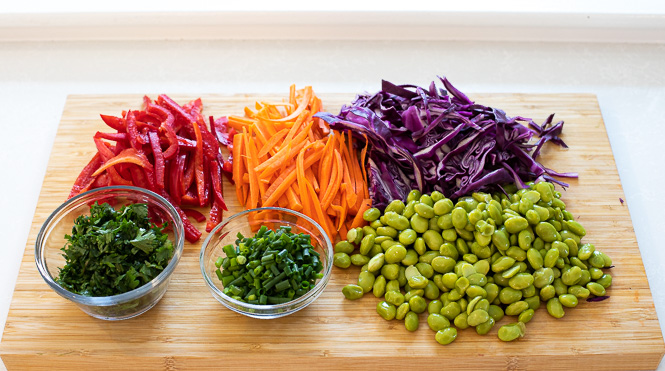 Vegetables prepped and chopped on a cutting board.