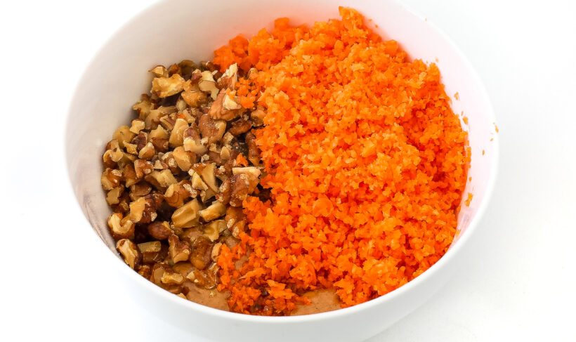 Ingredients for energy balls in a mixing bowl.