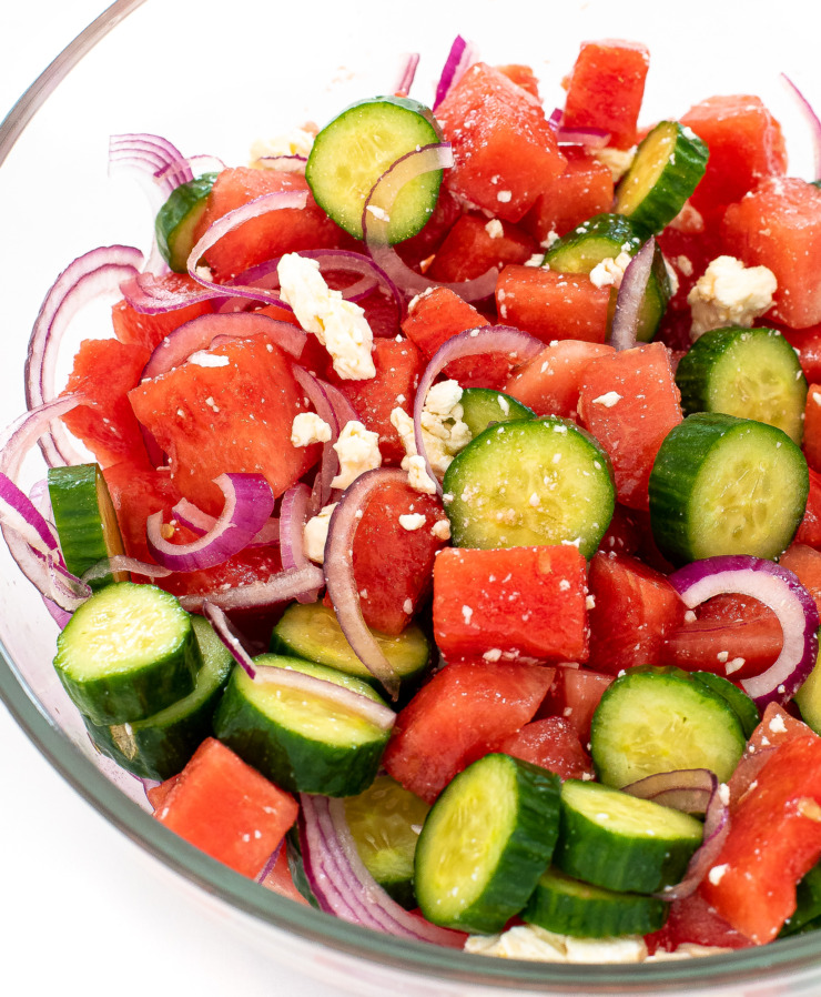 watermelon cucumber feta salad in large clear bowl