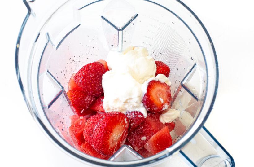 Watermelon strawberry smoothie ingredients in a blender before being blended.