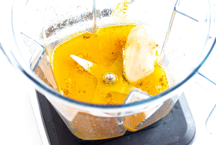 Ingredients for wellness glow shots in a blender before being blended. 
