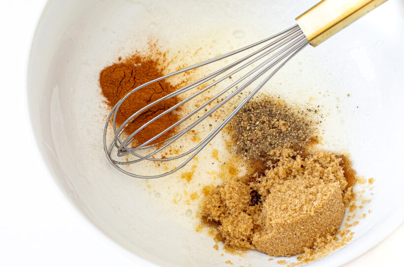 Whisking ingredients for candied walnuts.