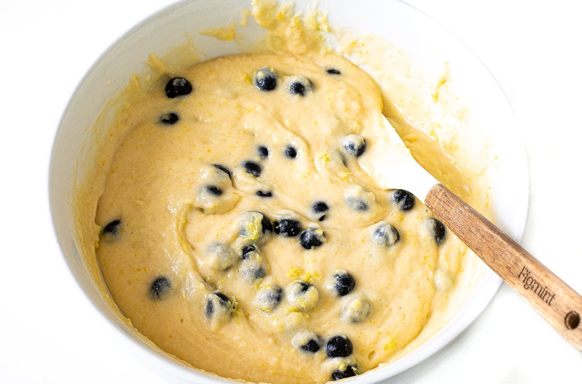 folding in blueberries to lemon loaf bread batter