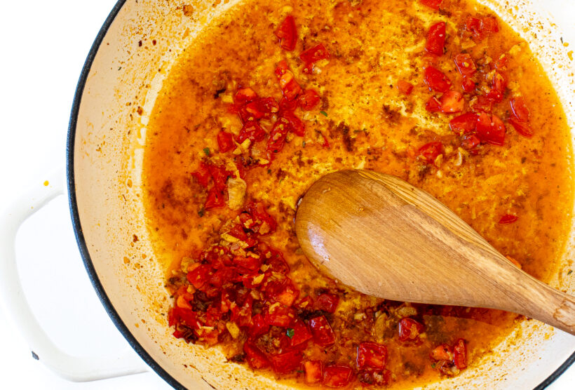 A spoon stirring the Cajun sauce.