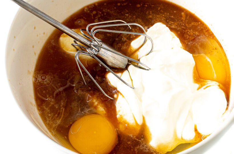 Whisking wet ingredients for blueberry cake.