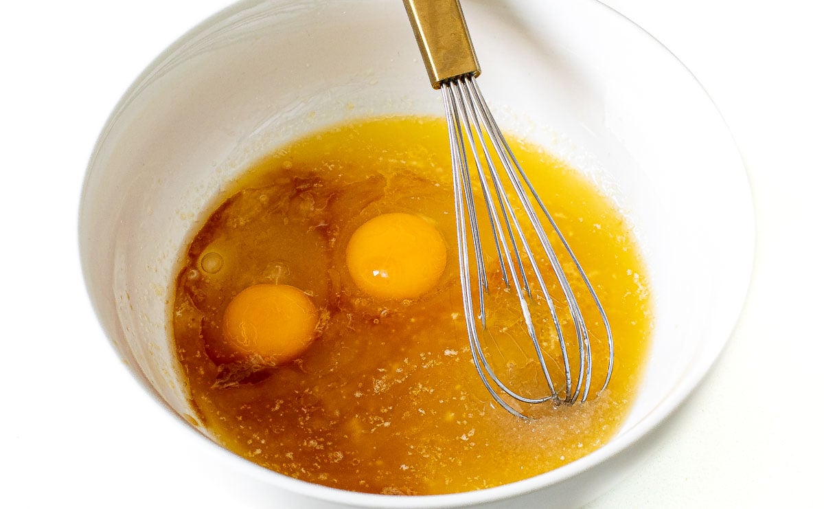 combining wet ingredients in large bowl with a whisk