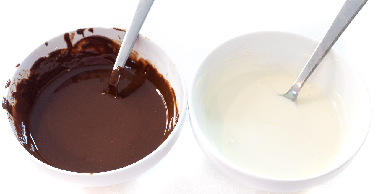 melted white chocolate and milk chocolate in white bowls