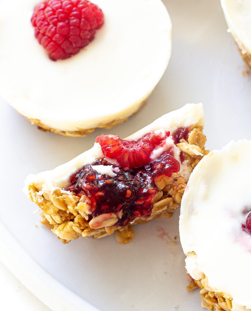 White chocolate oat cup in half showing the layers of oats, jam and white chocolate.