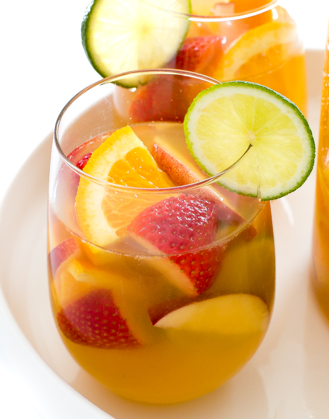 white wine sangria in wine glass with lime slice