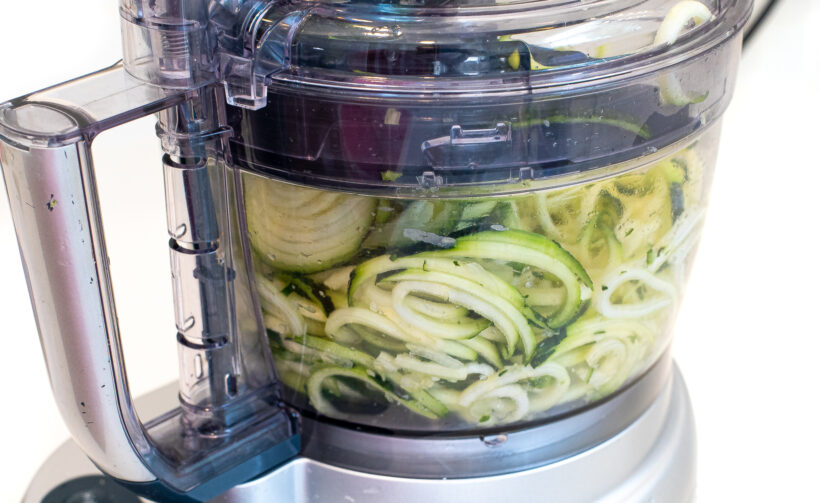 Zucchini inside a food processor. 