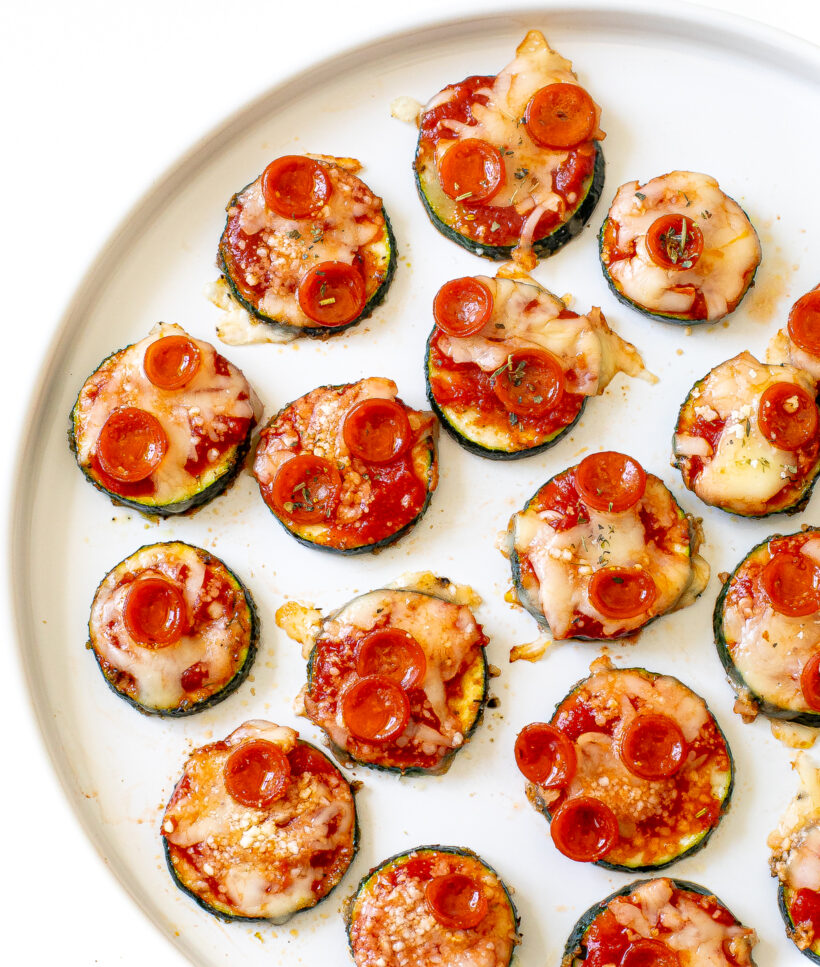 Zucchini pizza bites served on a white plate.